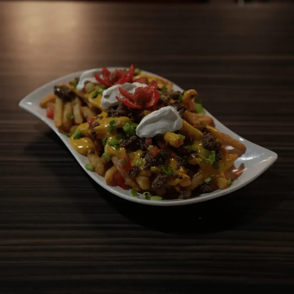 Loaded chili cheese fries with sour cream, tomato and green onion