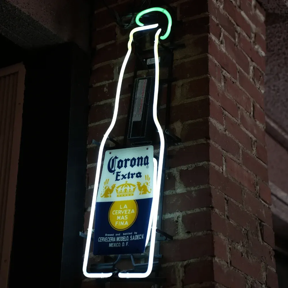 The Corona bottle neon sign on the brick wall