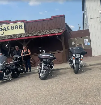 Motorcycles parked out front of Kicks Saloon