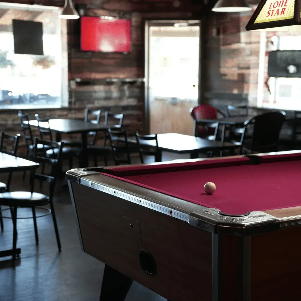 The dining room and red-felt pool table at Kicks Saloon