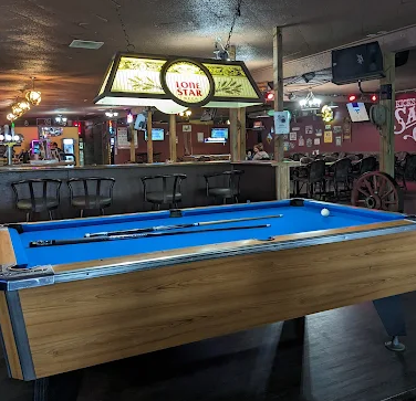 The pool table under a Lone Star lamp at Kicks Saloon